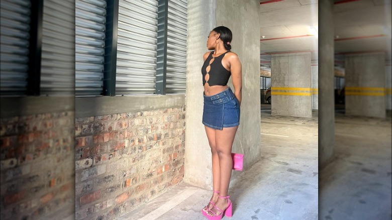 person in wrap front denim skirt