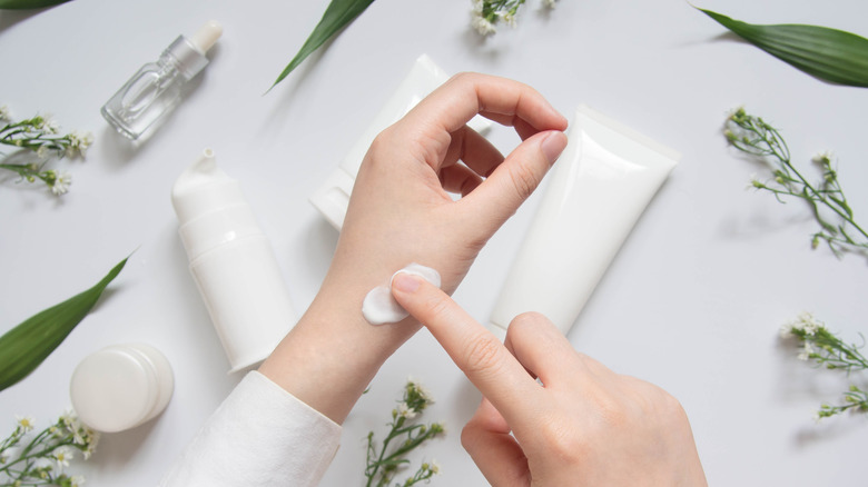 Hands applying product