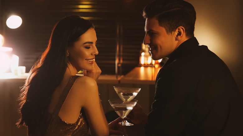 Man and woman at bar drinking and flirting