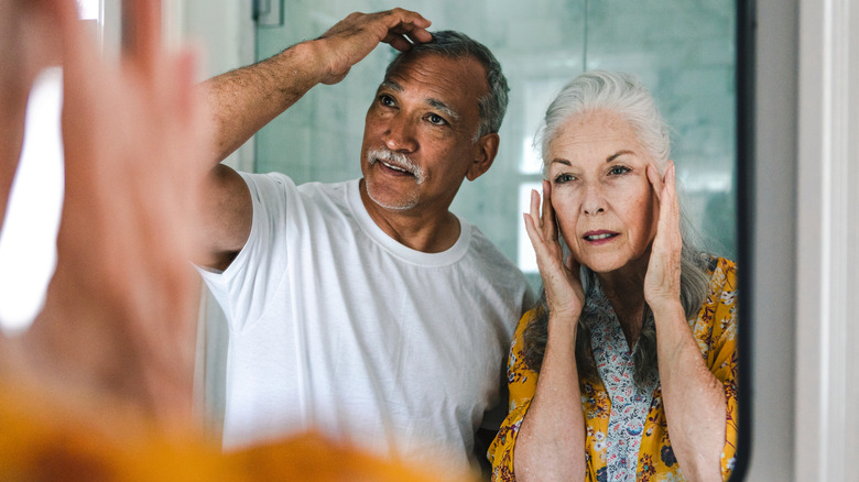 Man and woman in front of mirror