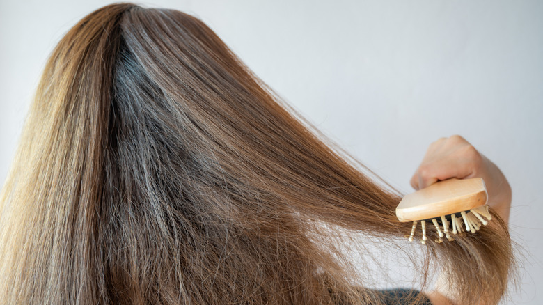 woman brushing messy hair