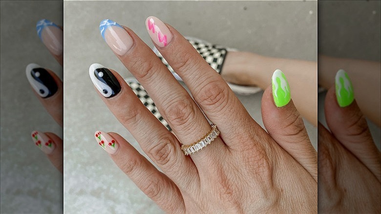 hand with mismatched dip powder nails