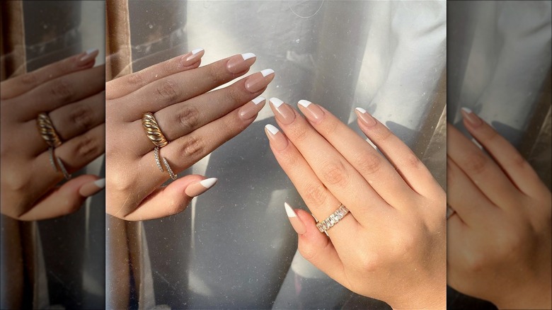 hands with half french tip dip powder nails