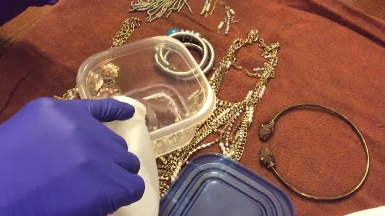 Gloved hand pouring ammonia