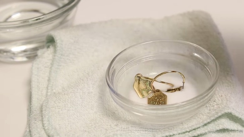 Jewelry submerged in baking soda paste