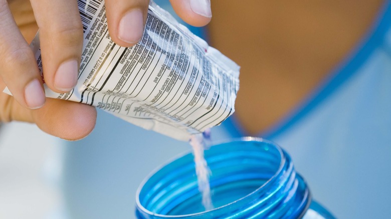 Hydration multiplier being poured into a water bottle