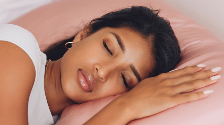 Woman sleeping on silky pillow
