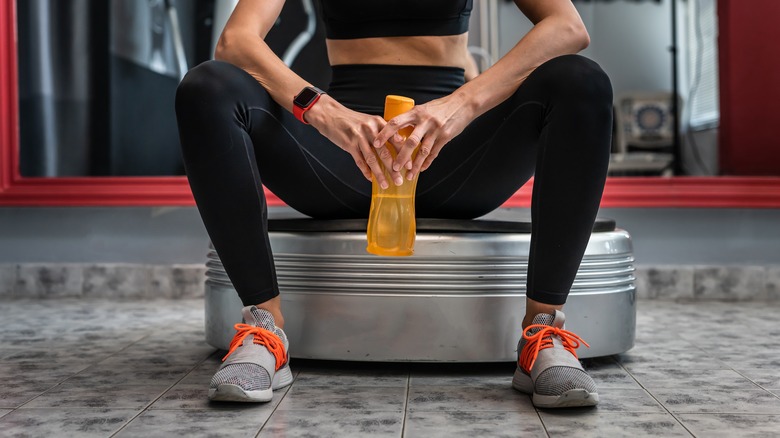 Woman resting on vibration plate
