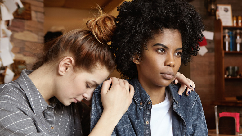 Couple in cafe appearing unhappy