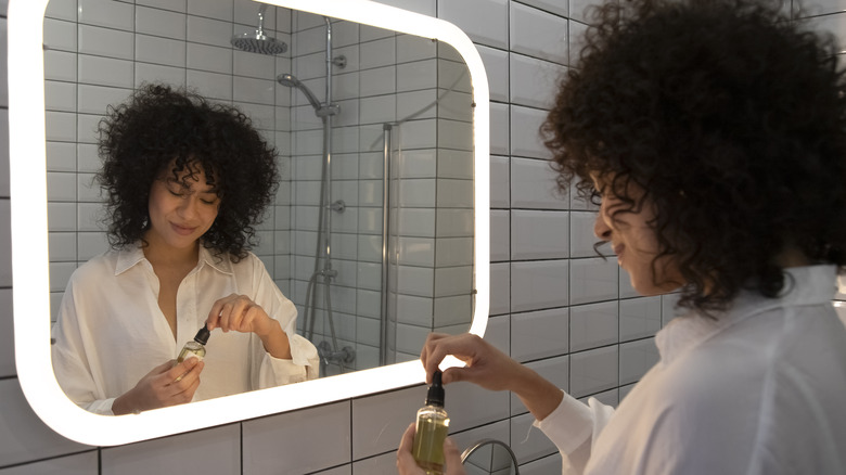 woman holding hair oil