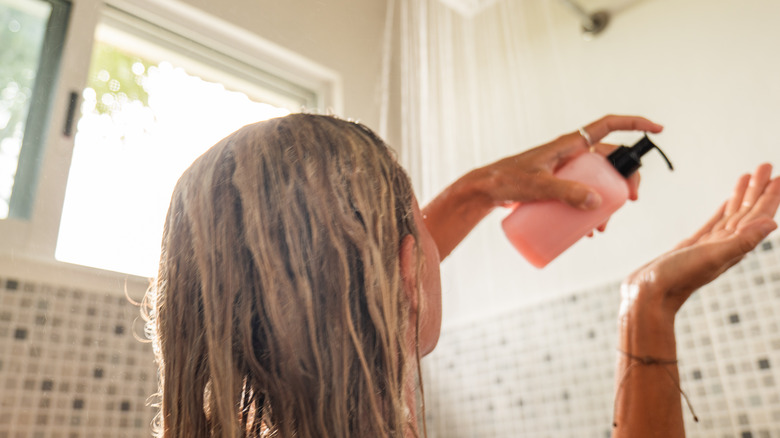 Woman dispensing soap in the shower