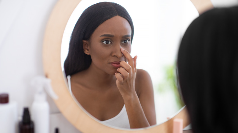 woman touching her nose