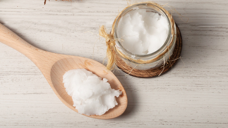 Coconut oil and a wooden spoon