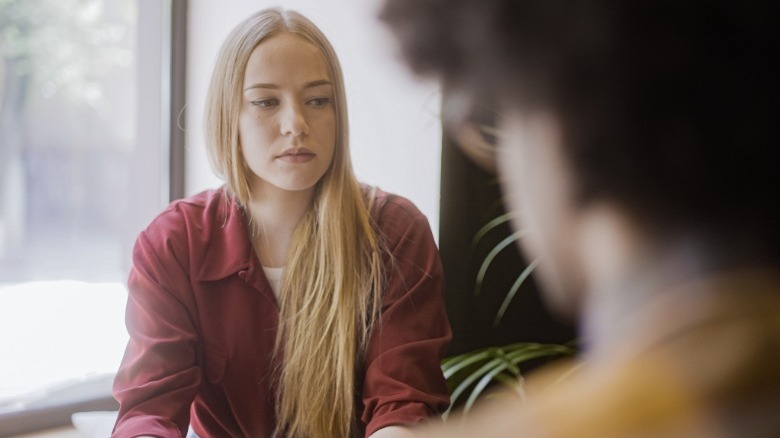 Woman looking away from man