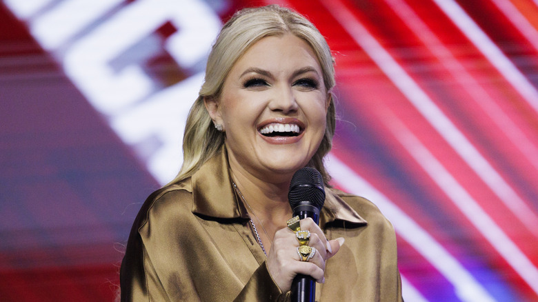 Erika Kirk laughing into a microphone on stage