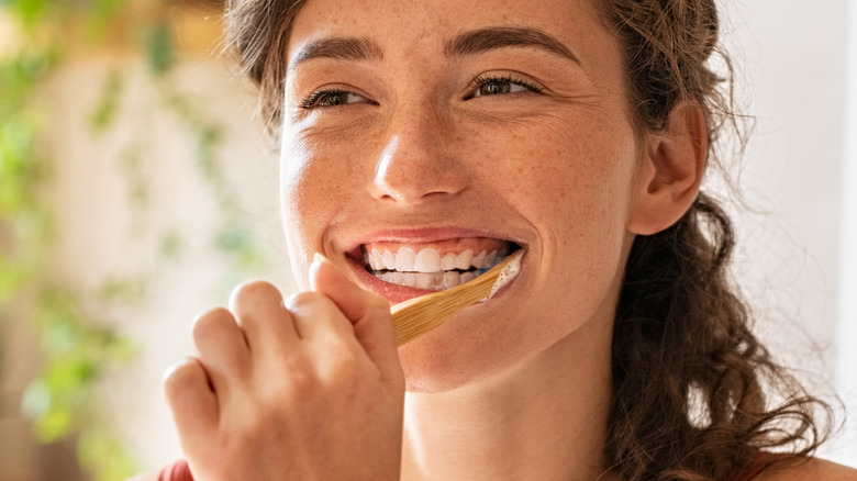 woman brushing teeth