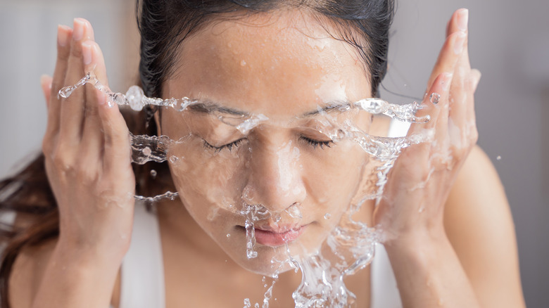 Woman washing her face