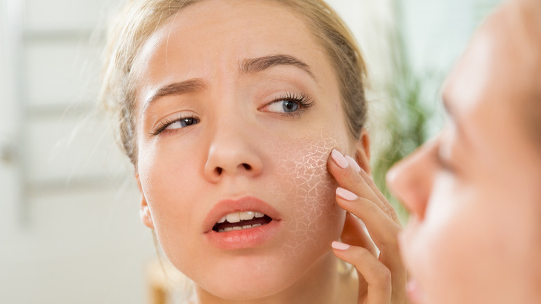 Woman looking at dry skin