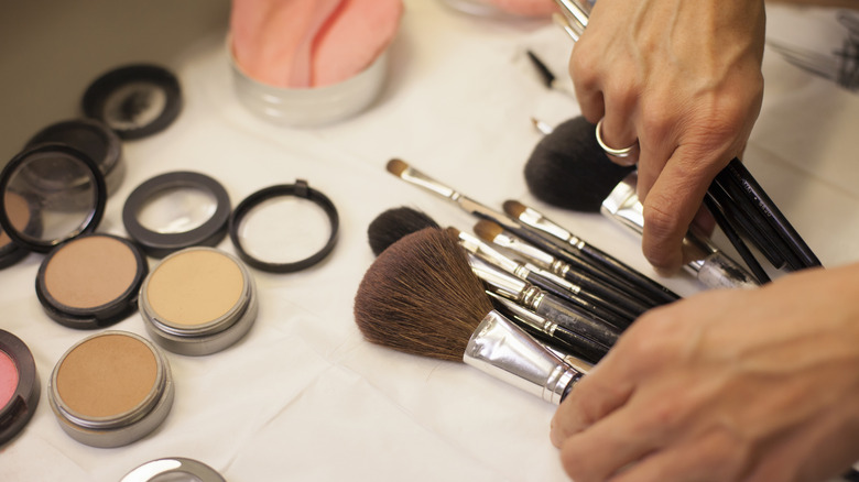 A woman organizing her makeup brushes.