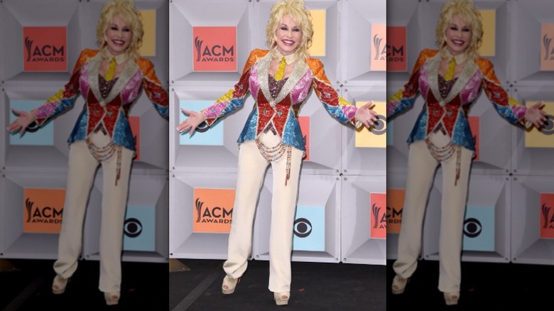 Dolly Parton poses in a technicolor coat at the ACMs