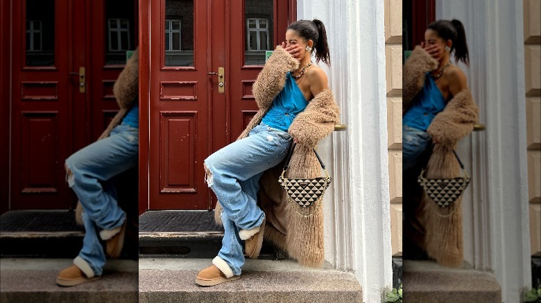 Girl carrying Prada triangle bag.