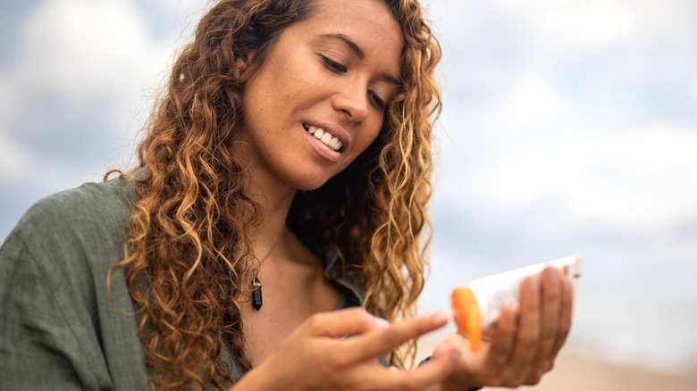 Woman applying sunscreen