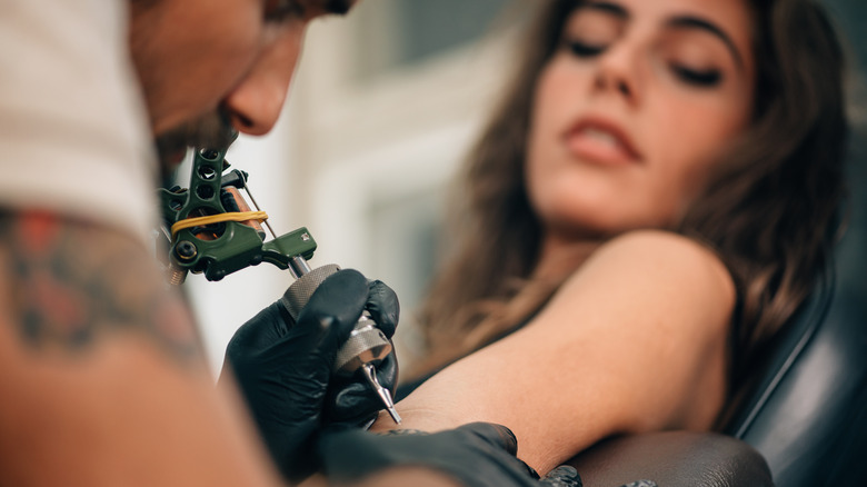 Woman getting a tattoo