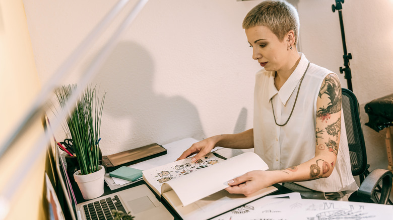 Tattoo artist with portfolio