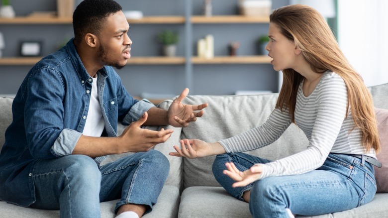 Couple arguing on the couch