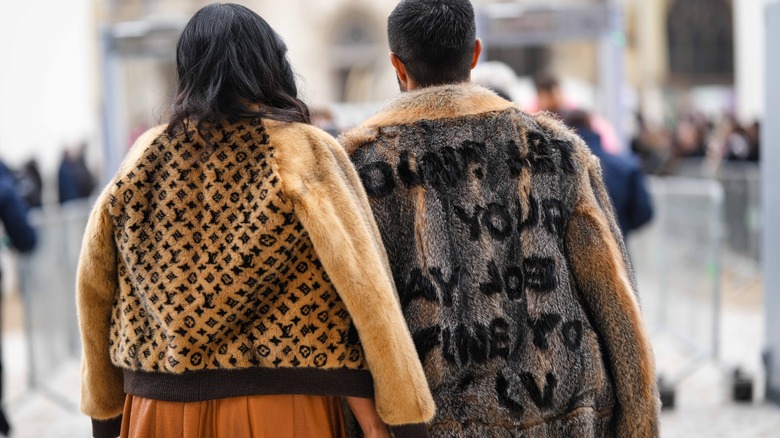 Couple dressed in branded clothing