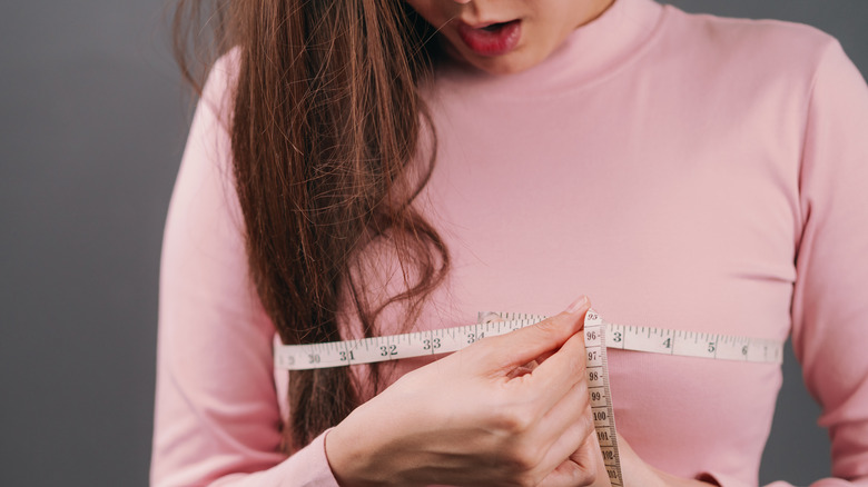 woman measuring her chest
