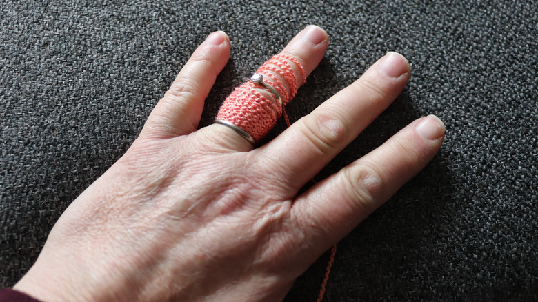 person removing stuck ring