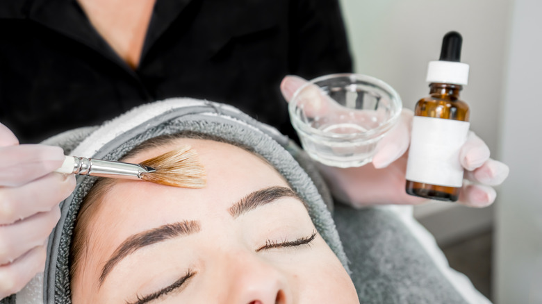 woman applying chemical peel