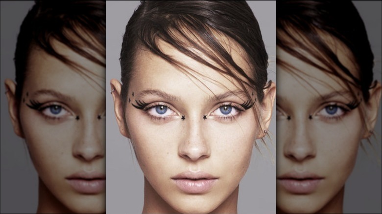 A woman wearing lash-like eyeliner