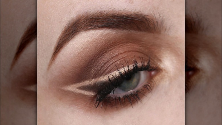 A woman with negative space eyeliner