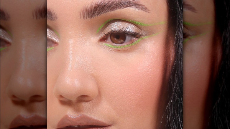 A woman with neon green eyeliner