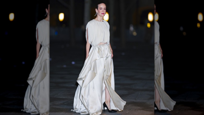 Sarah Paulson leaves an event in a drapey cream-colored dress