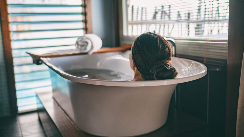 Woman soaking in tub