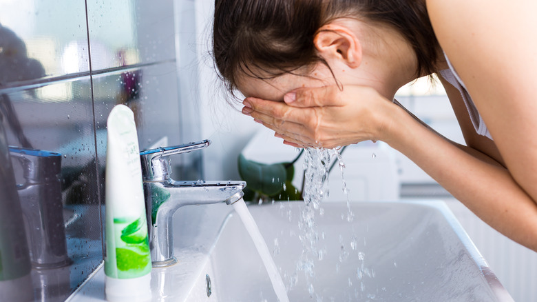 woman washing her face