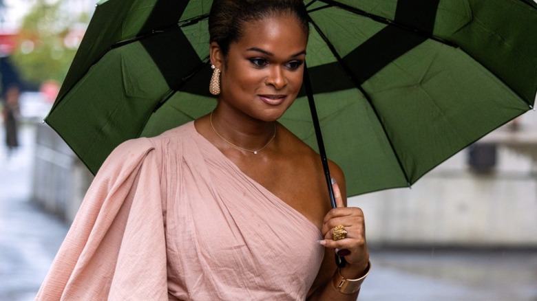 Woman in asymmetrical blush blouse