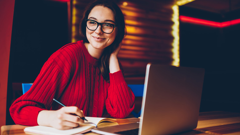 smiling woman with notebook