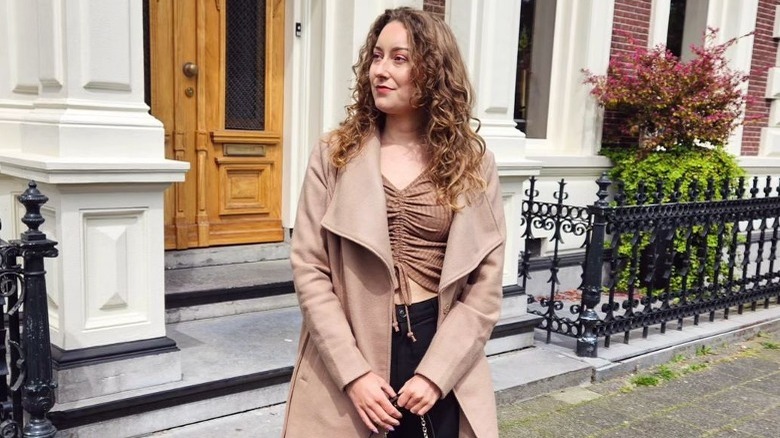 Woman poses with natural earth blond curls