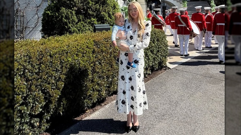 Tiffany Trump in a fashion disaster matronly dress posing for a photo at the Easter egg roll