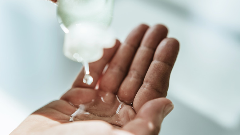 Hand sanitizer being squeezed onto hand