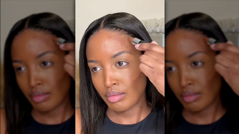 Woman using lipstick as contour