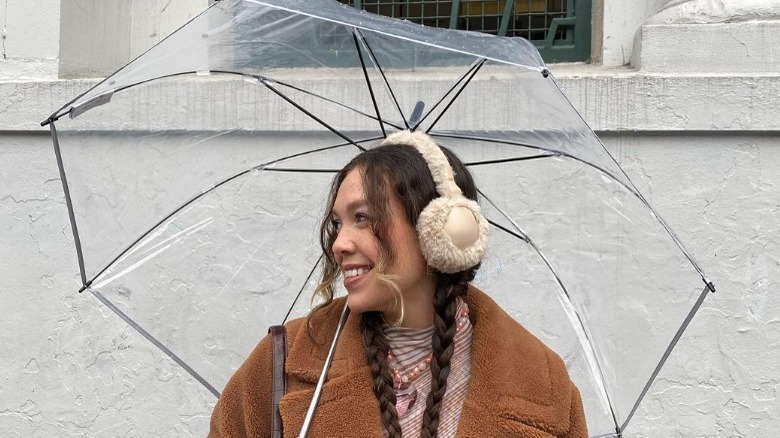 Woman wears fuzzy earmuffs 