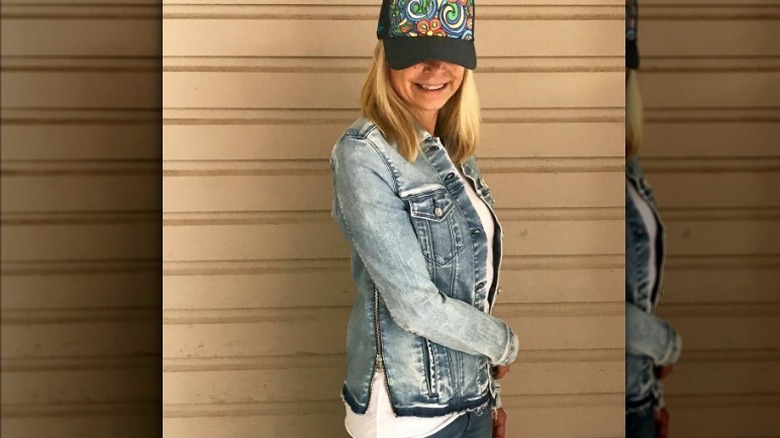Woman wears side-zippered denim jacket