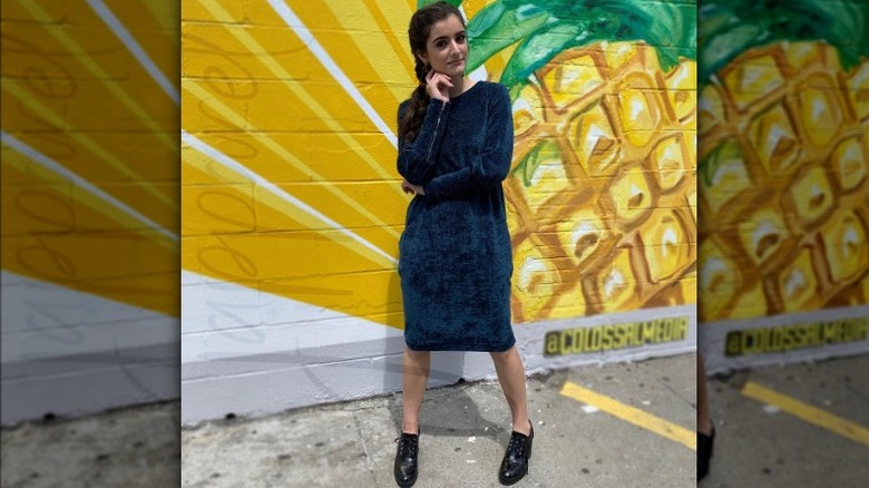 Woman wears velvet dress with zippered sleeves 