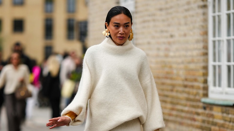Woman wearing white turtleneck sweater