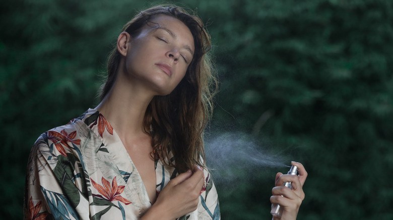 woman using body mist